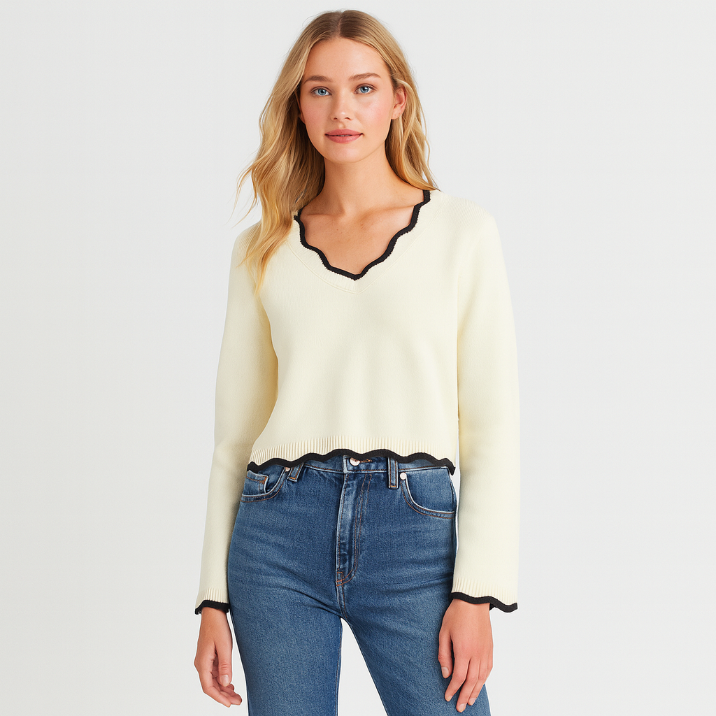 Long-sleeve knit sweater with a scalloped V-neckline, scalloped hem, and scalloped cuffs.