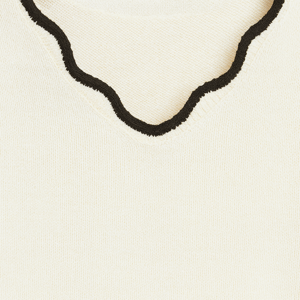 Long-sleeve knit sweater with a scalloped V-neckline, scalloped hem, and scalloped cuffs.