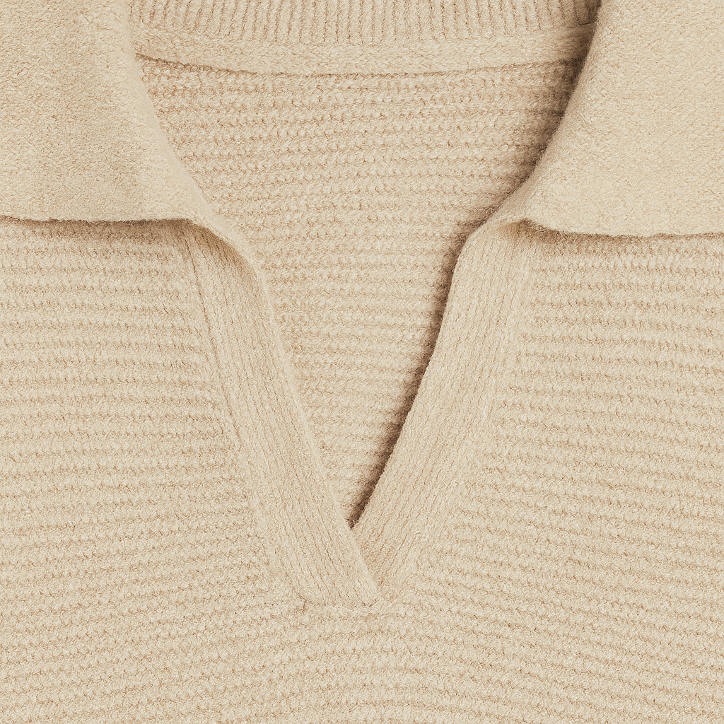 Ribbed knit sweater with a wide collar, V-neckline, long sleeves, and a fitted hem and cuffs.