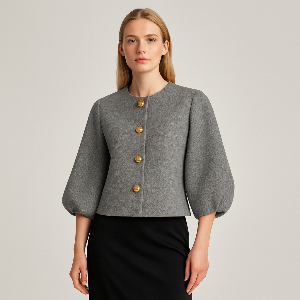 A cropped jacket with a round neckline, long sleeves, and four large metallic buttons down the front.