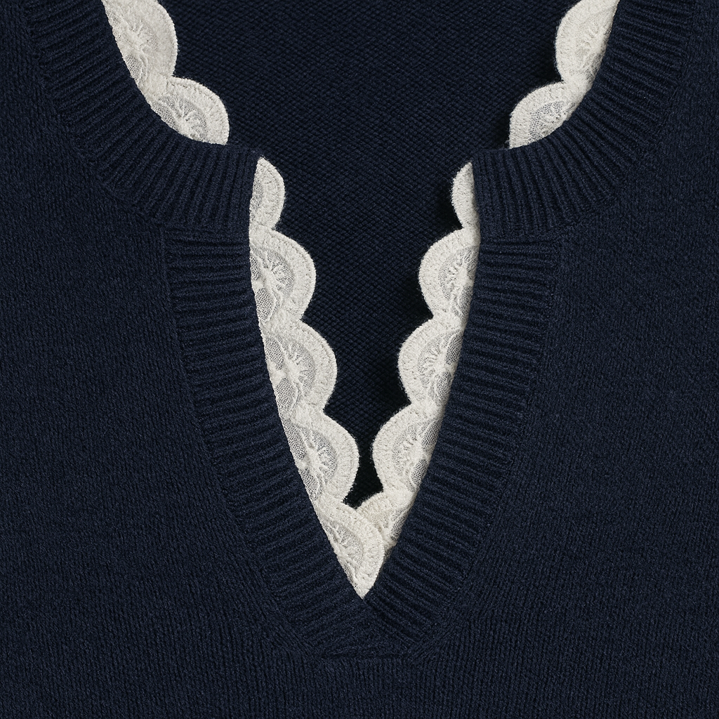 Sweater featuring a V-neckline with scalloped lace trim, long sleeves, and ribbed detailing at the cuffs and hem.