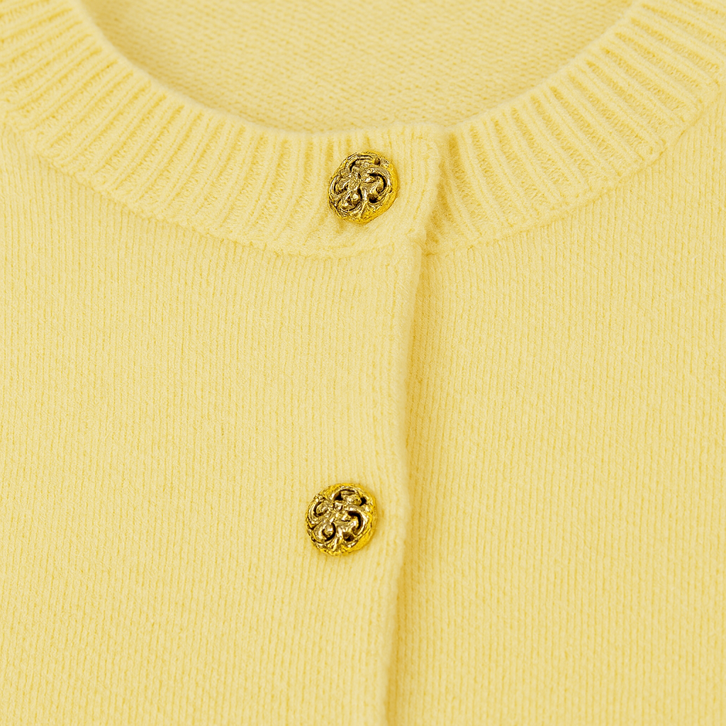 Cardigan with a crew neckline, long sleeves, ribbed cuffs and hem, and decorative metallic buttons down the front.